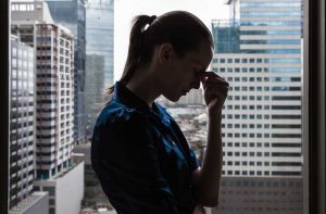 concerned woman standing with her head in her hand - opiate withdrawal timeline - Fair Oaks Recovery Center of california - sacramento drug rehab and opiate detoxification center
