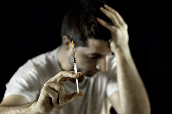 heroin overdose effects on family - man with heroin needle - Fair Oaks Recovery Center