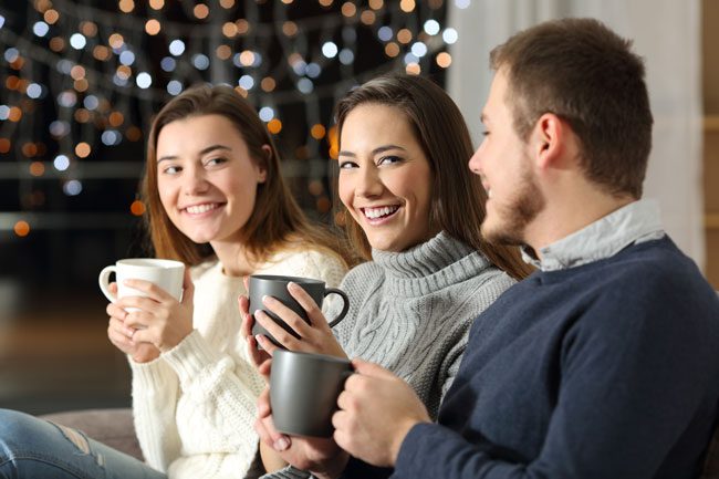 How-to-Emotionally-Prepare-for-the-Holiday-Season - friends or siblings enjoying coffee holiday time