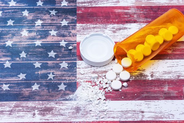 substance use disorders, Substance Abuse Public Health Crisis, pills spilled and crushed on US flag