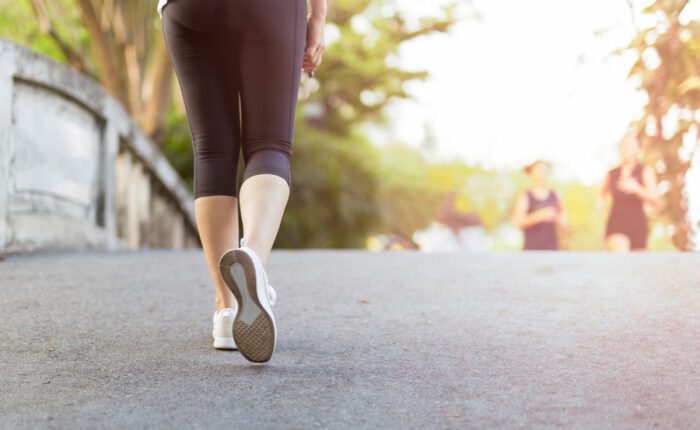 person walking on a road exercising