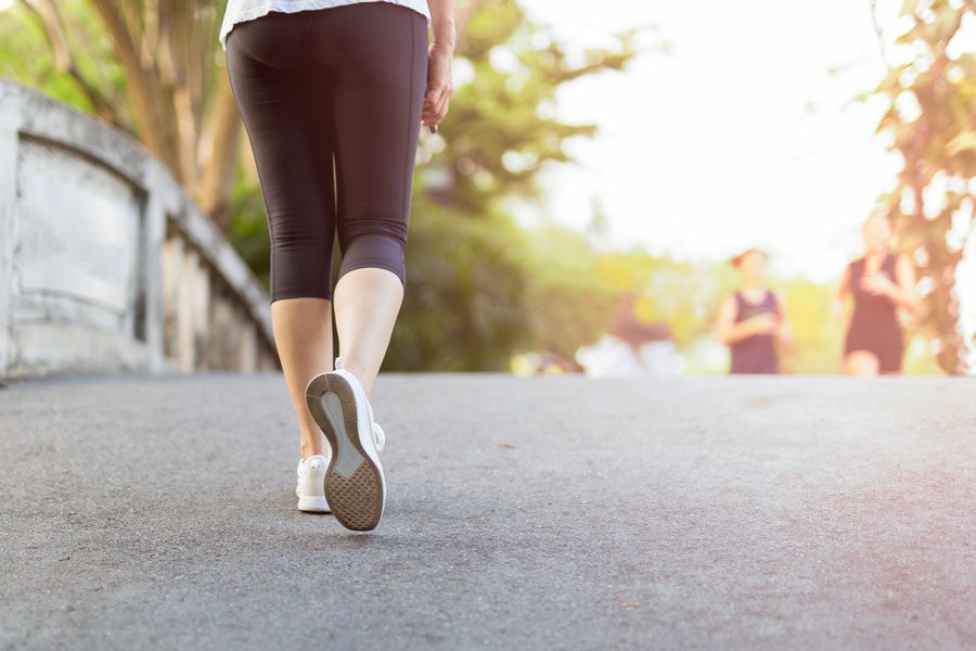 person walking on a road exercising