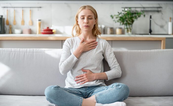 Woman doing calming breathing exercises